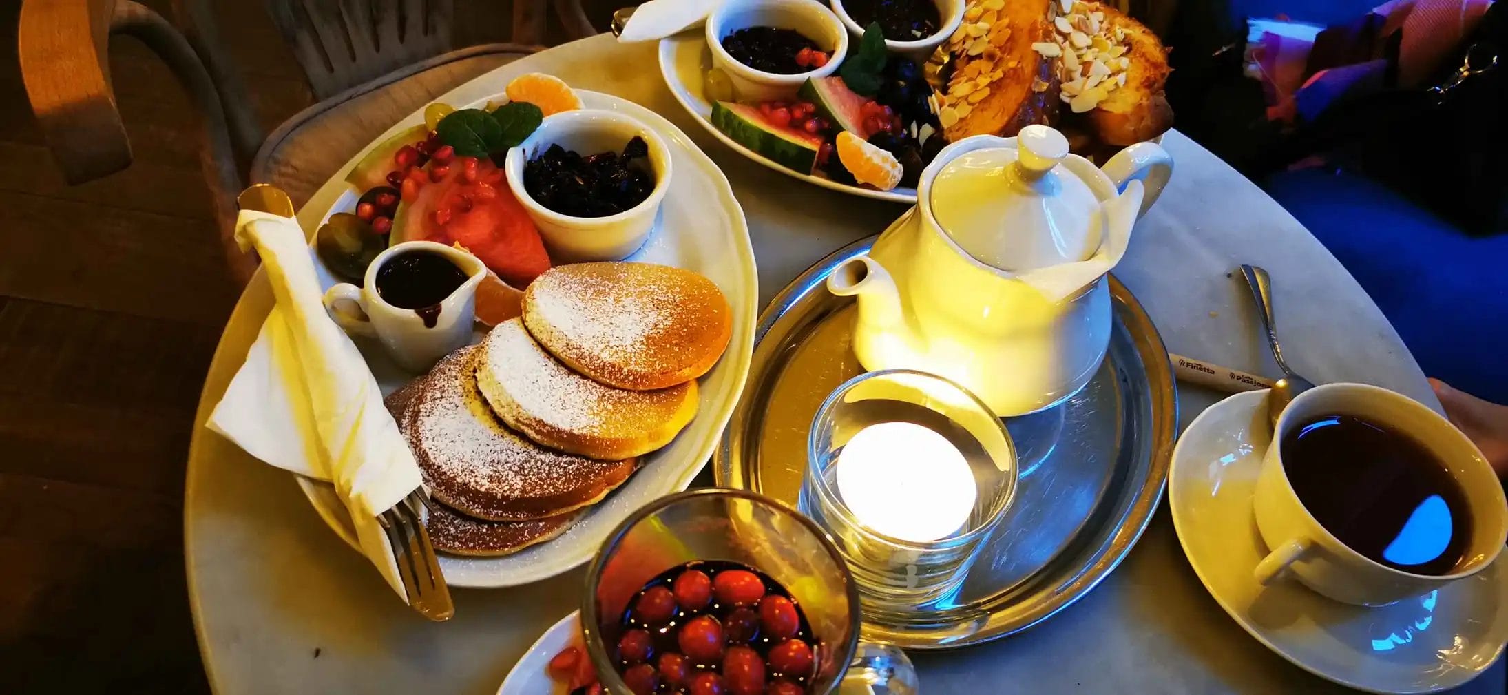 a plate of food and a teapot in a coffee store in Old Town Krakow